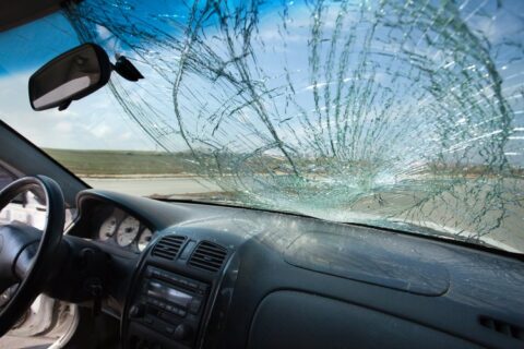Fractured car windshield with spiderweb cracks across the glass in Jacksonville, FL
