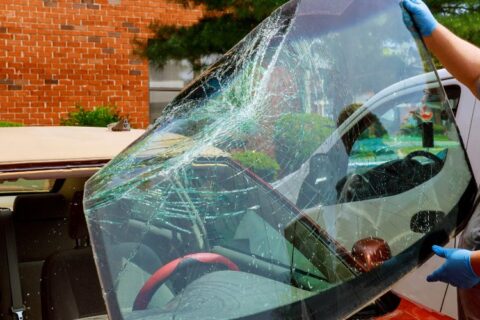 Auto glass technician installing a new windshield on a vehicle in Jacksonville, FL
